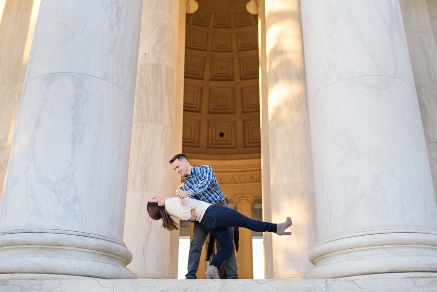 A fun couple dancing between the columns behind the Lincoln Memorial for their DC Engagement Session.